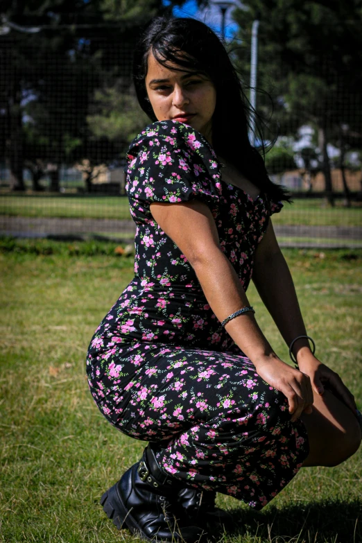 a beautiful woman in a floral print dress posing for a po