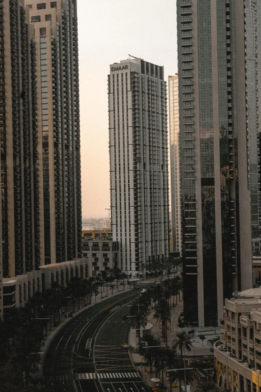 some very tall buildings and a couple of traffic lights