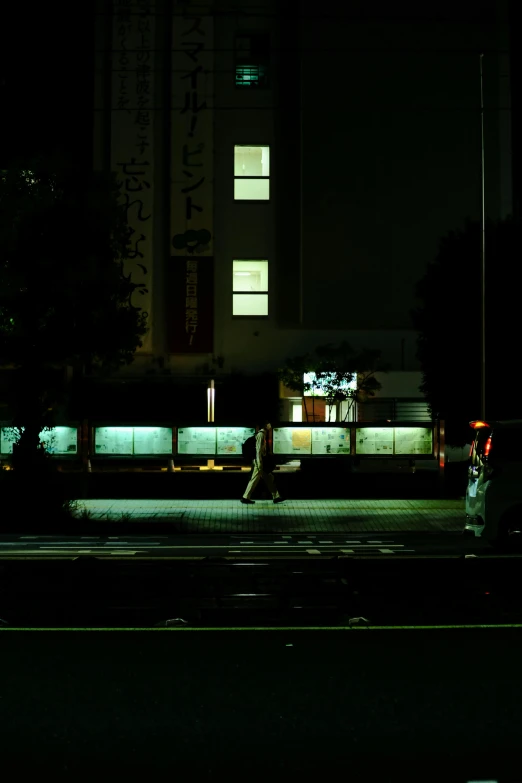 a man walking down a street at night