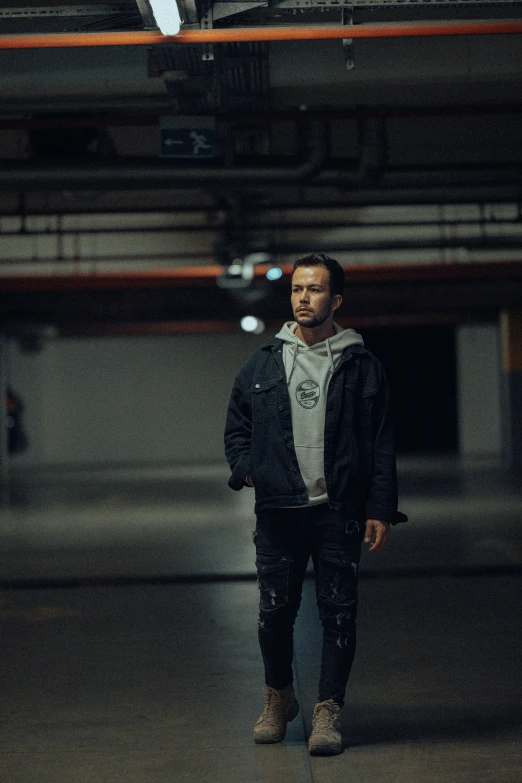 a man standing in the middle of a parking lot