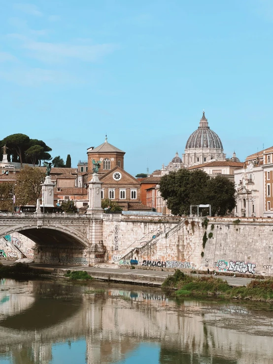 a view of the city of rome and its reflection on a river