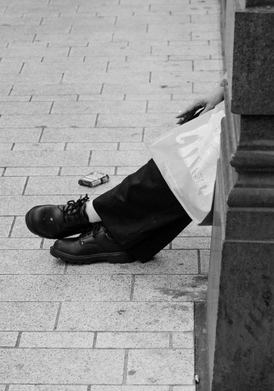 a man sitting on the ground with his head in his hands