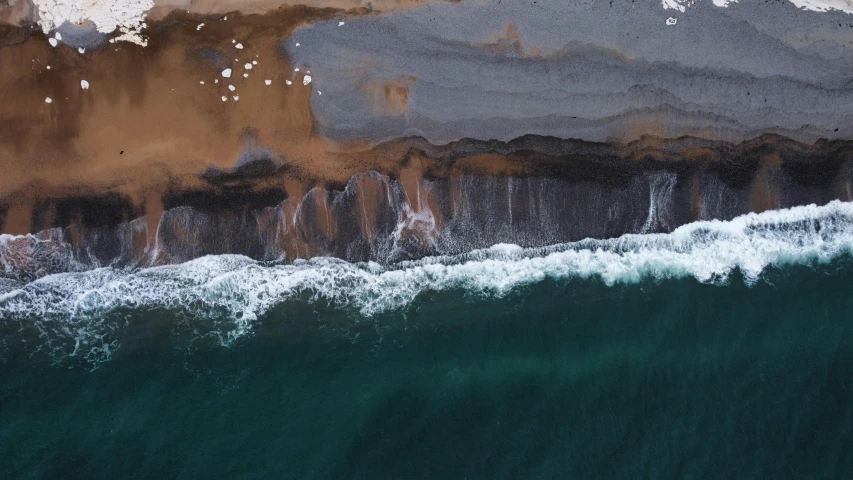 an overhead view of water next to shore