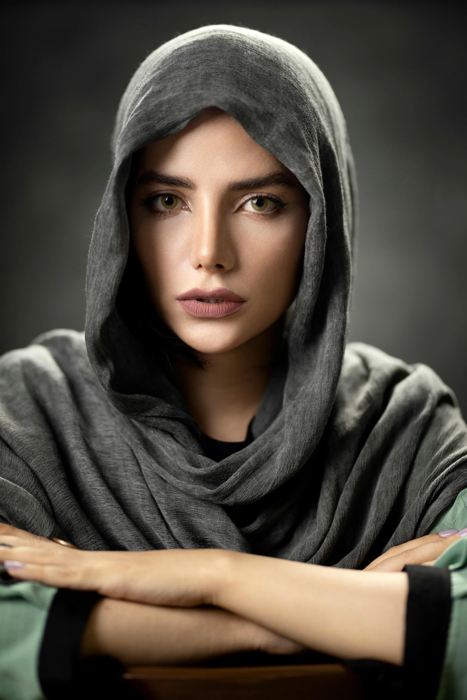 an image of a woman with a grey cloak on