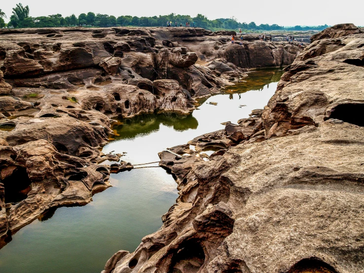 a lake with some water in it next to large rocks