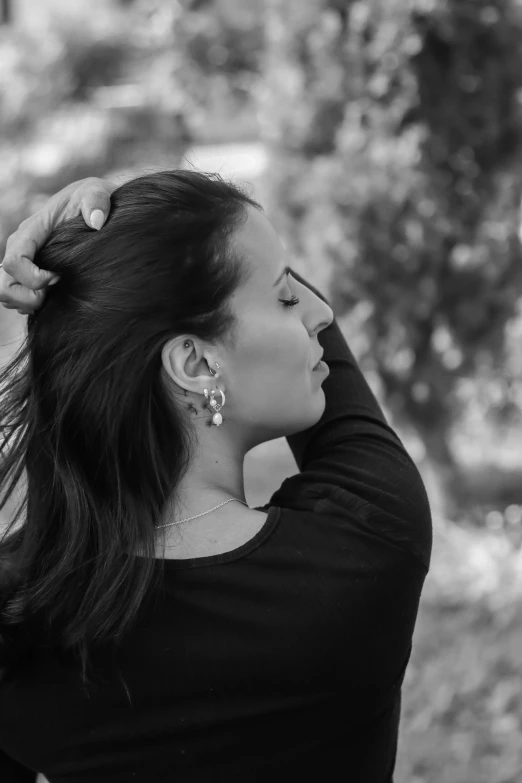 a woman holding her hair in the wind