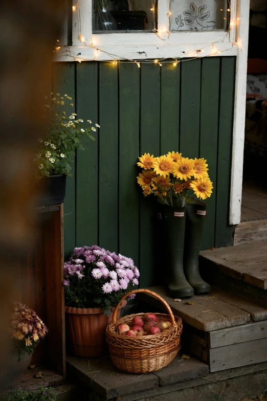 a basket and flowers sit on the steps