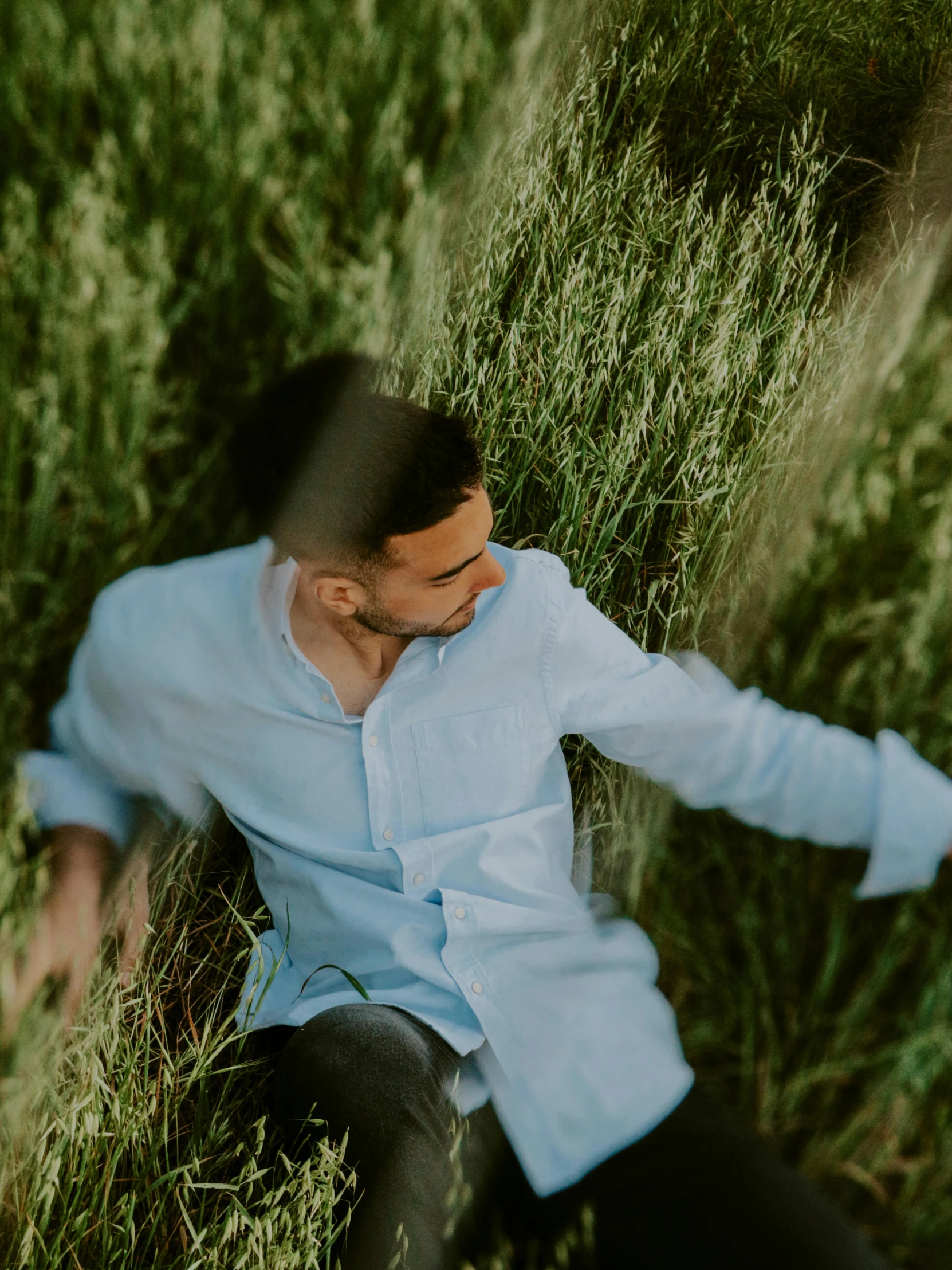 a man in the grass resting in his pants