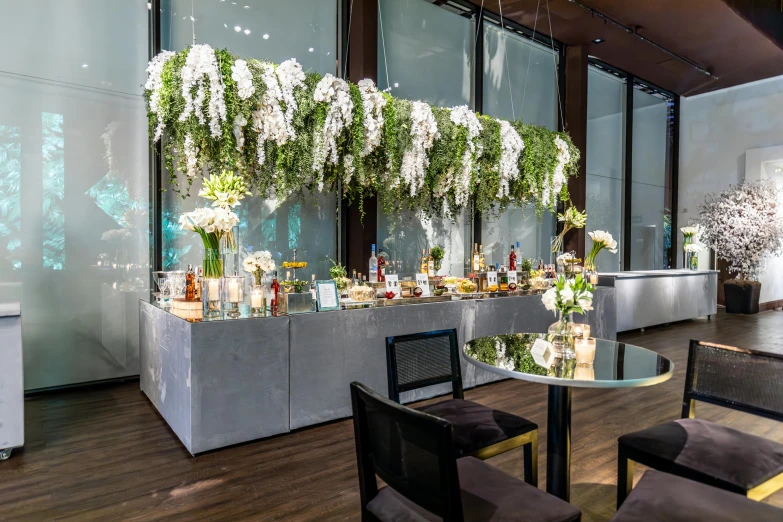 a room filled with lots of tables covered in glass and flowers