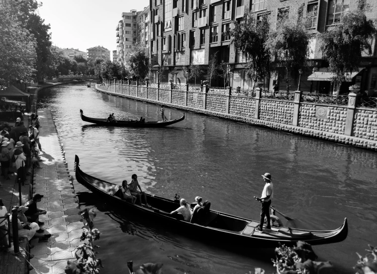 two people riding in a boat while others watch