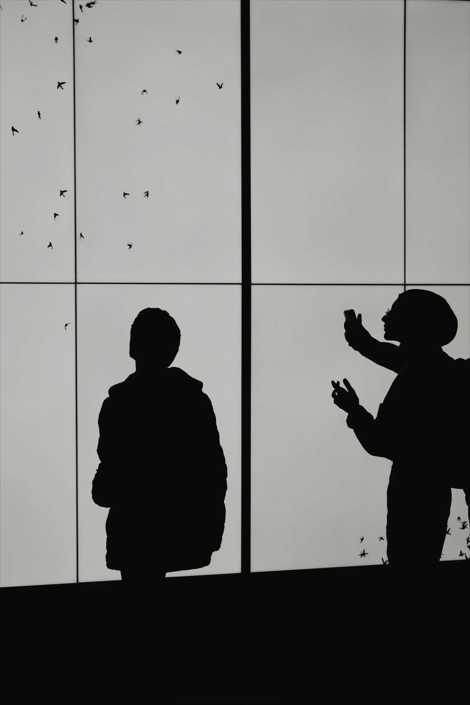 a man looking out an office window in the dark