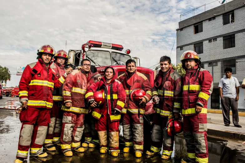 a group of men and women are dressed in fire suits