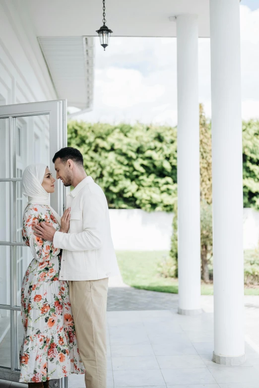 a couple in love is hugging each other at a home