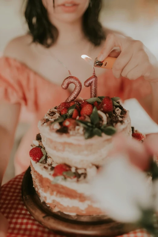 a woman blowing out candles on her birthday cake