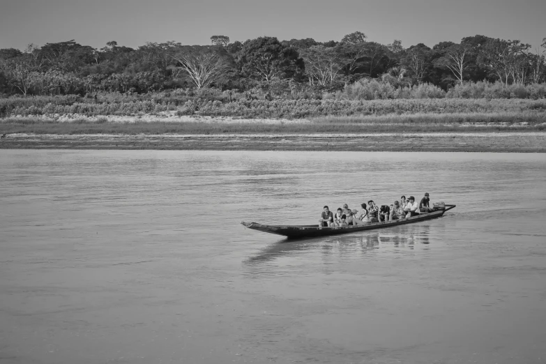 a black and white po of people in a canoe in the water