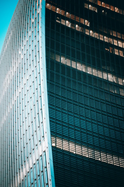 looking up at a blue building with many windows