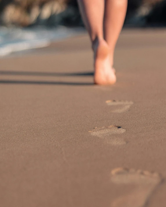 the beach is full of footprints from feet and feet