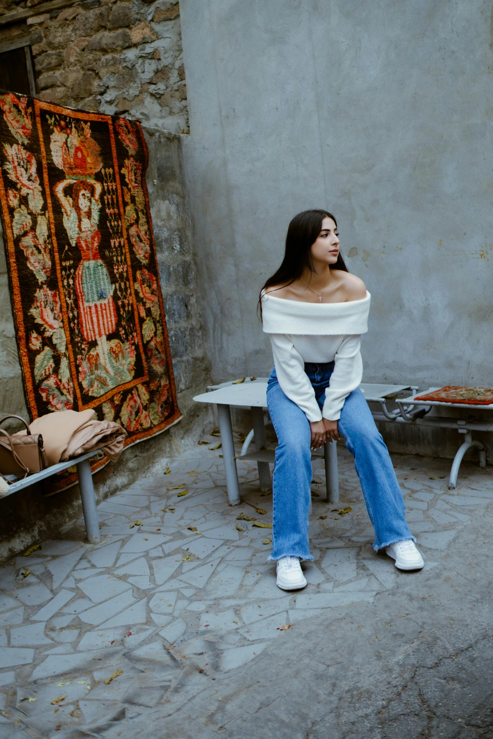 a woman sitting on a bench outside a building