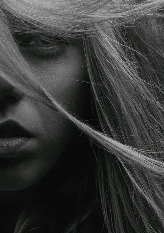 a woman with hair in her blowing on her head