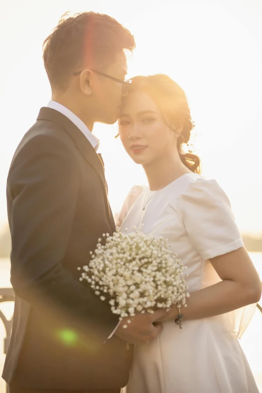 a bride and groom pose for a po at the pier