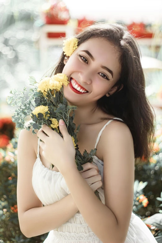 a woman in a white dress holding yellow flowers