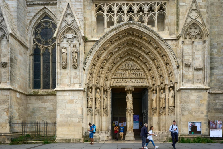 some people walking around the courtyard of a church