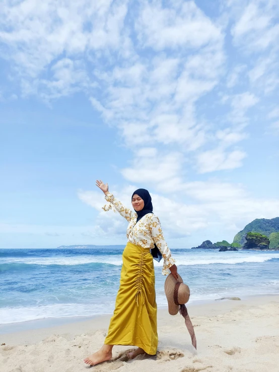 a person standing on a beach holding a cellphone