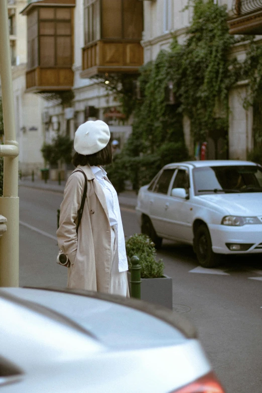 a woman walking down the sidewalk on her cell phone