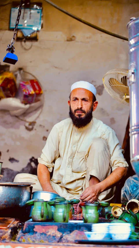 a man who is sitting down with a bowl