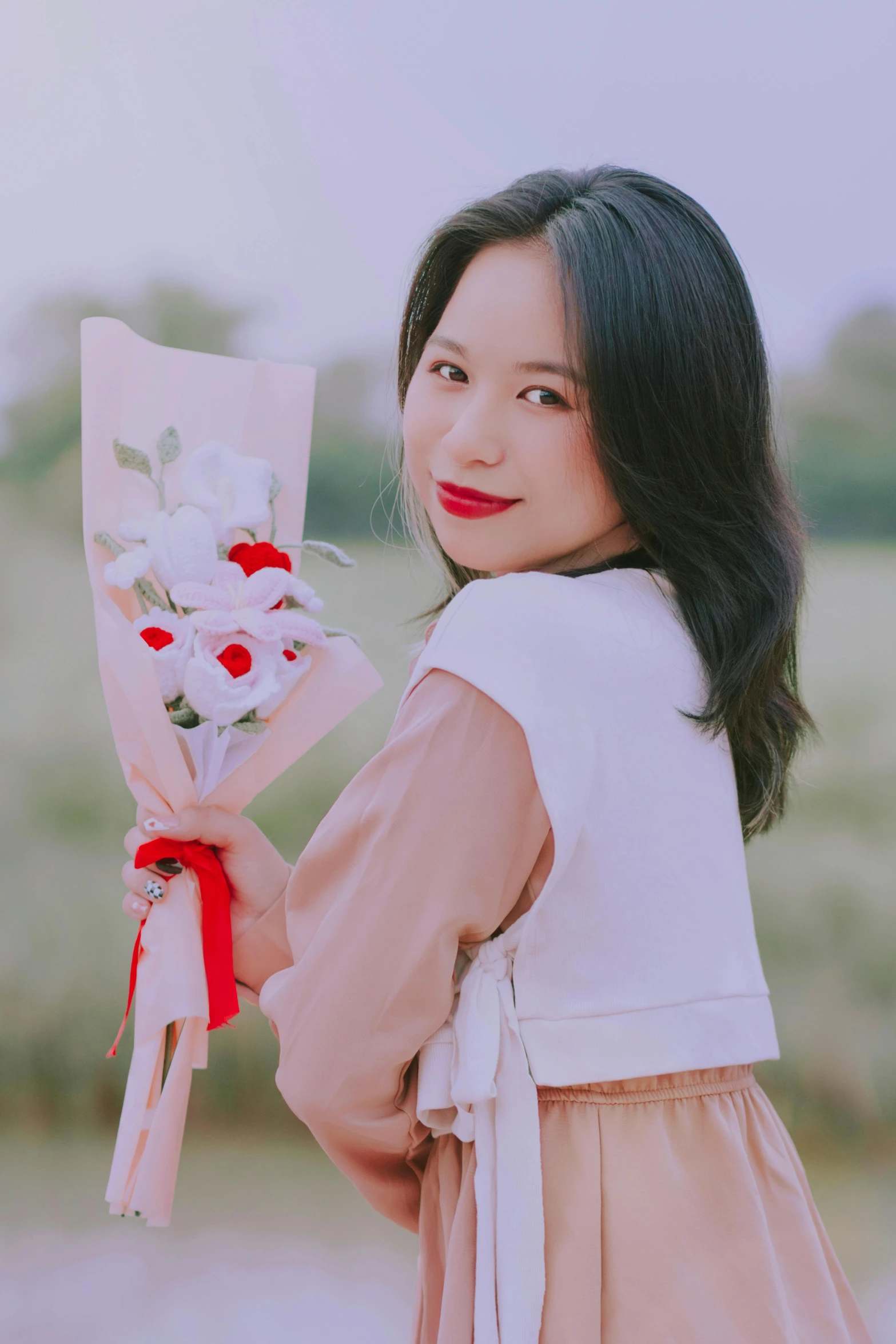 a young woman holding a bouquet of flowers