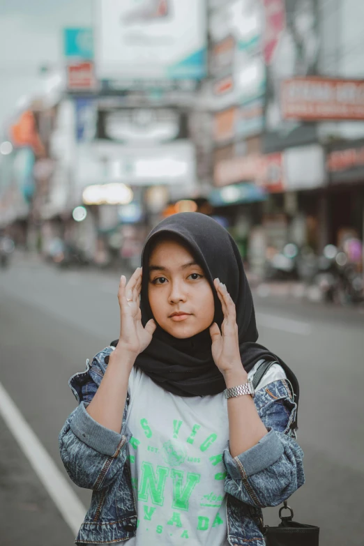 a young woman is on the phone in the street