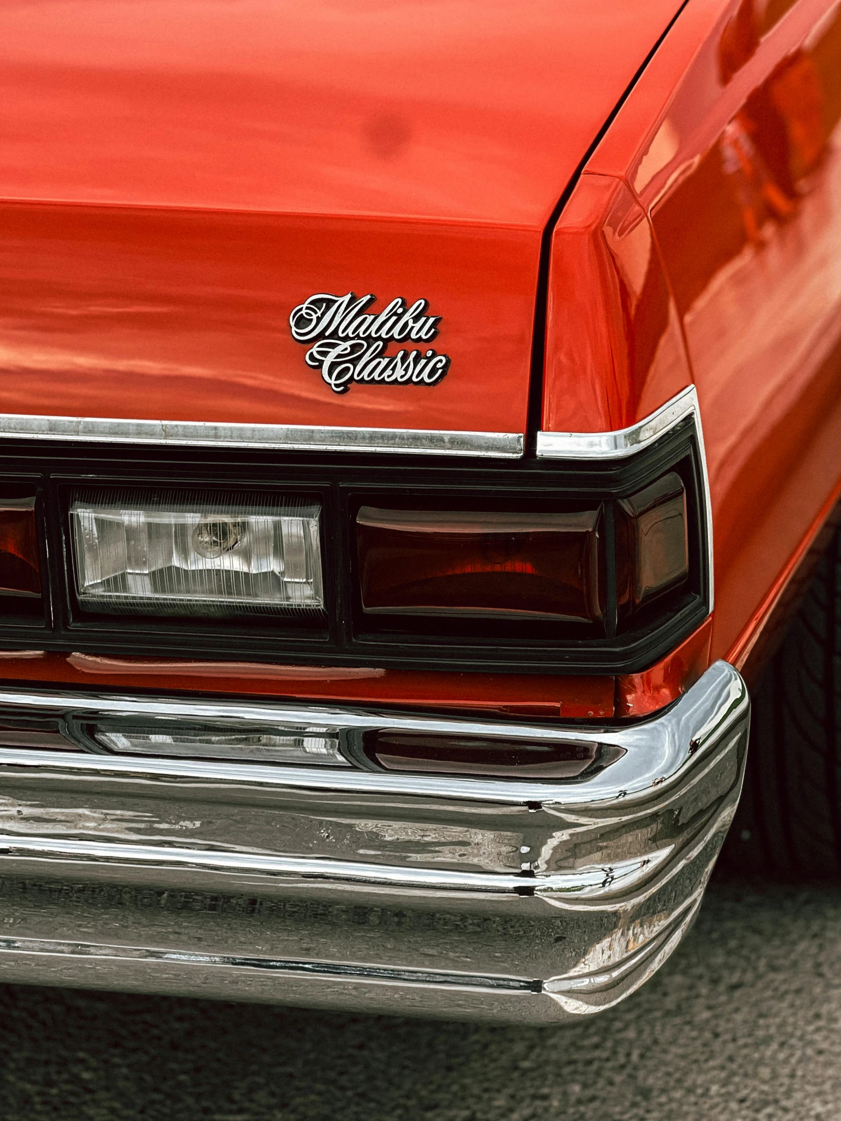 a red car with the name's logo on the front bumper