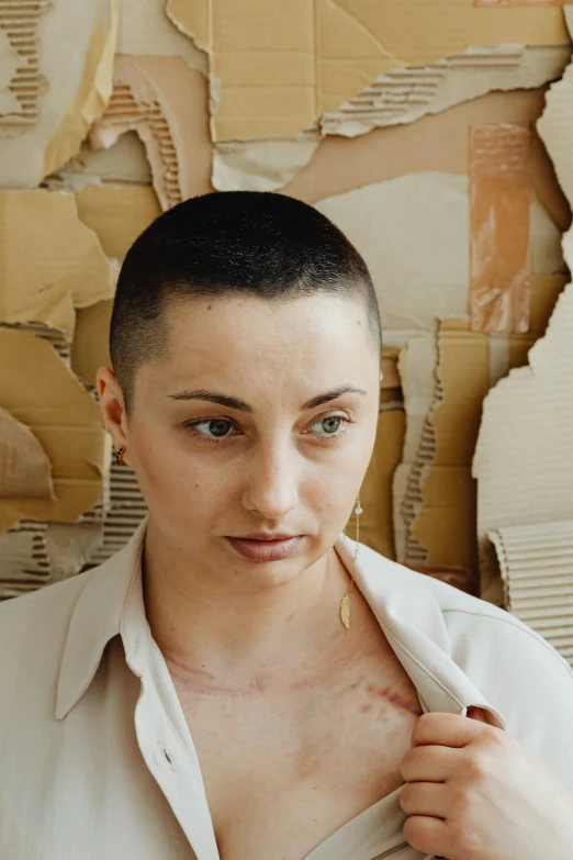 a woman in white shirt putting on earrings