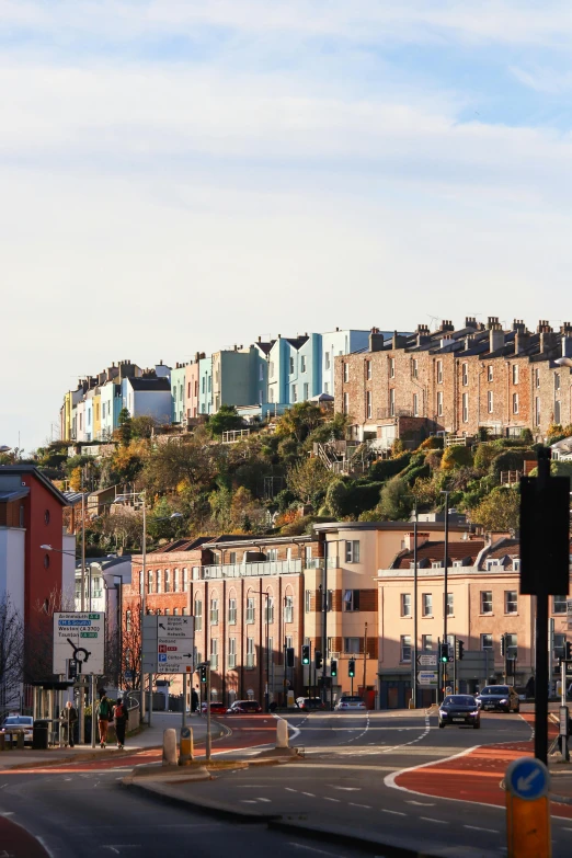 a city street with a hill in the background