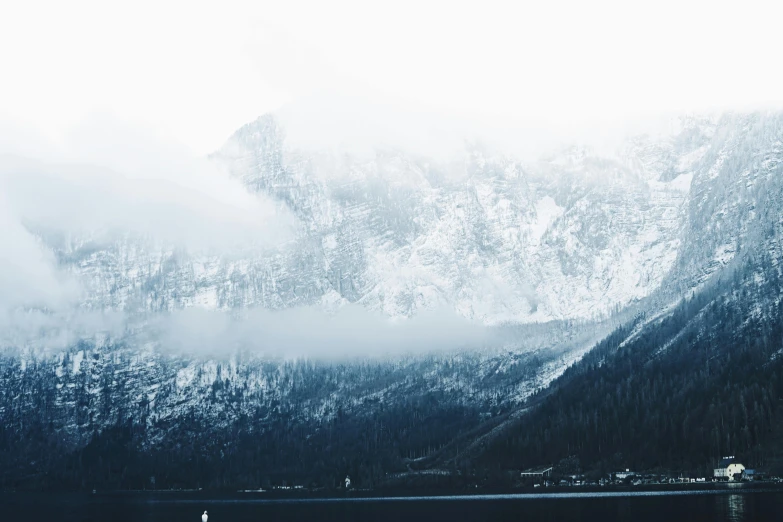 a large mountain range sitting next to a lake