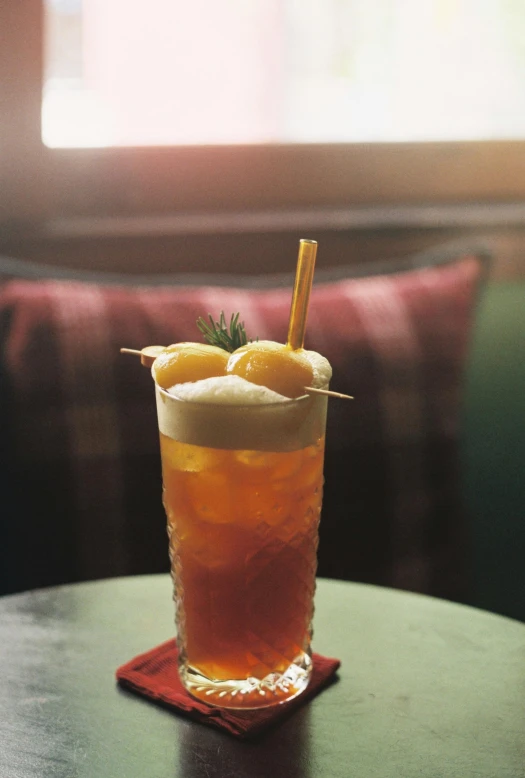 a small beverage cup with ice and orange slices