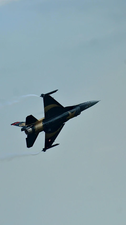 an jet plane flying sideways through the sky