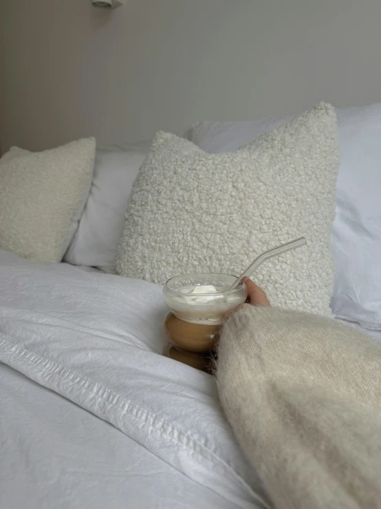 a person lying in bed holding a pillow