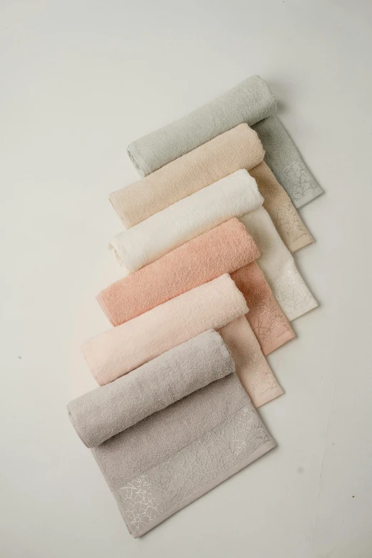 several different colors towels laid out on top of each other