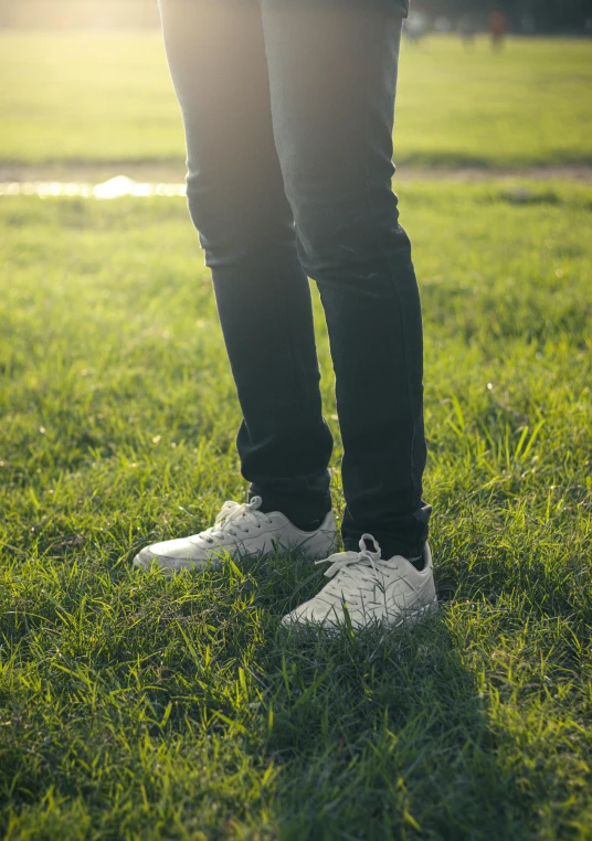 a person standing on top of a lush green field