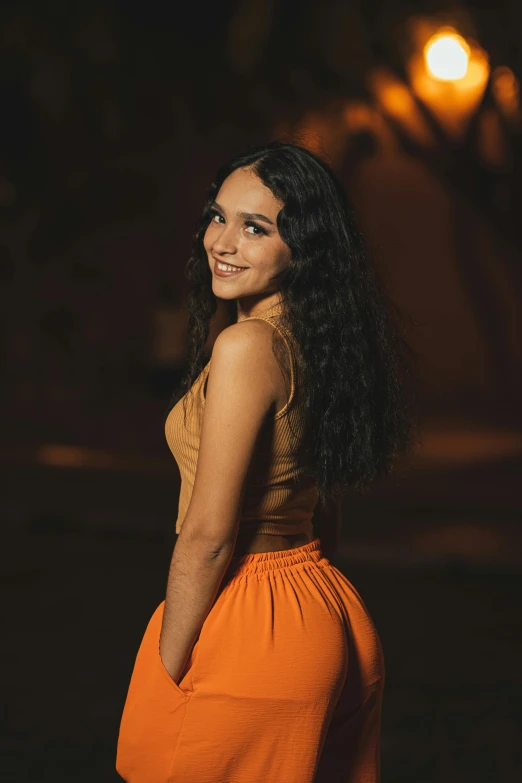 a woman in orange outfit looking into the distance