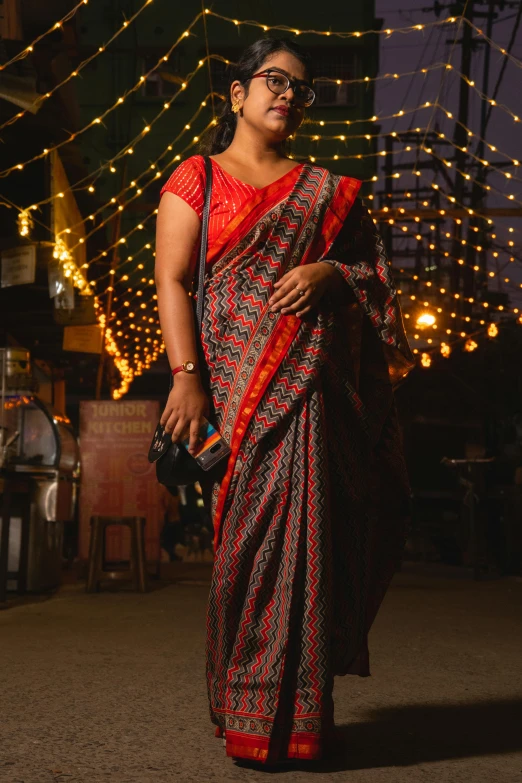 a woman is dressed in a bright sari