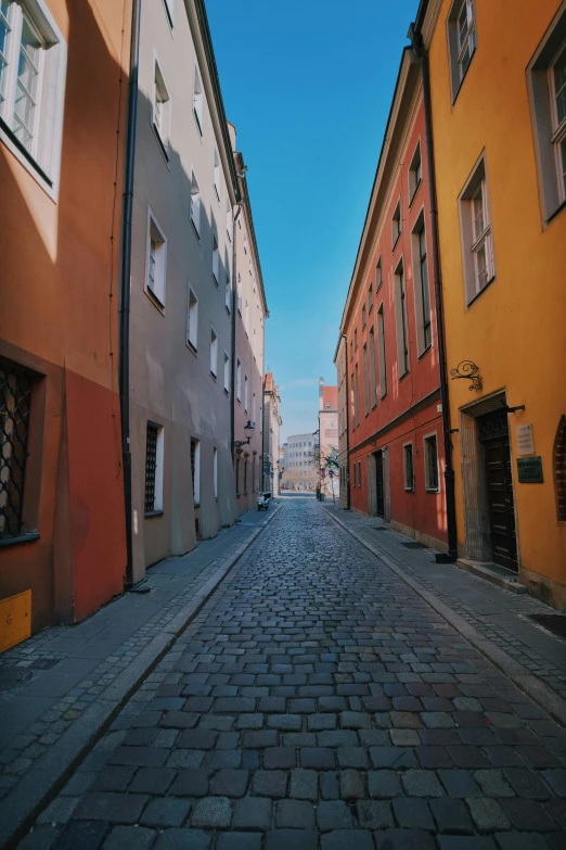 an empty street in an area with many older buildings