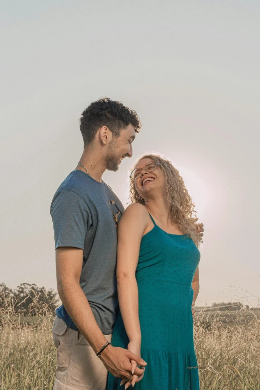 couple walking in a grassy field together