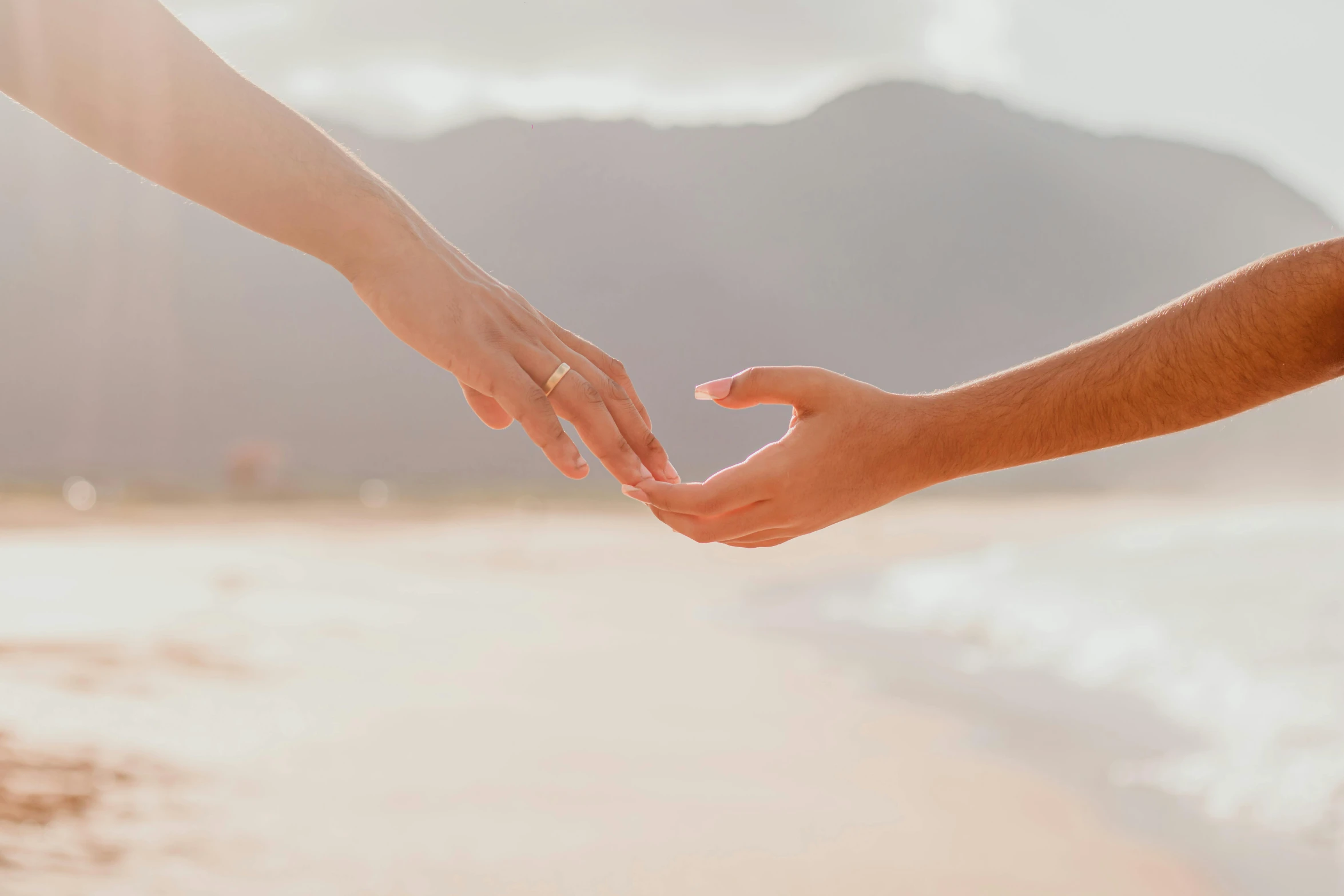 the person is touching their hands to touch another person's hand