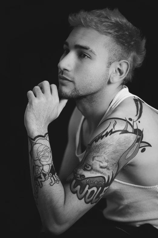 a man with tattoo is posing for a picture