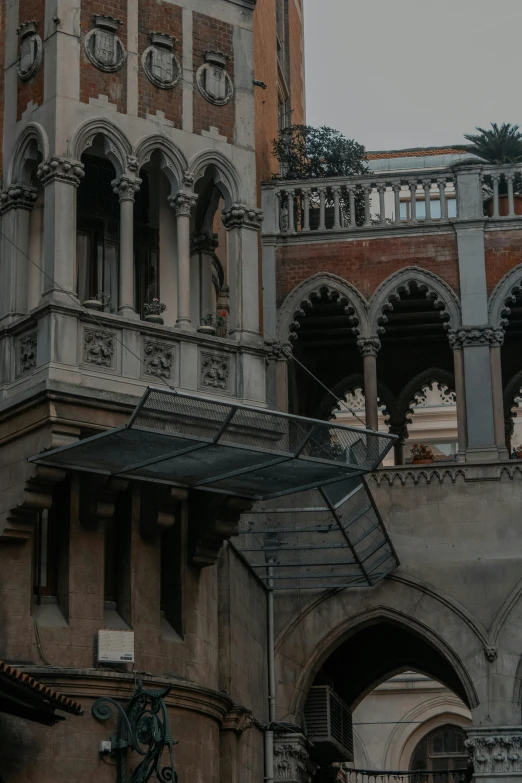 two large buildings with stairs and an ornate facade