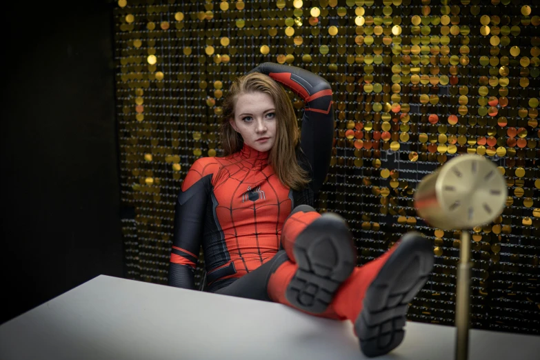 a woman is posed on a desk wearing a costume