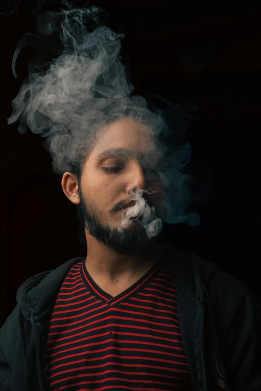 a man with his face covered in smoke