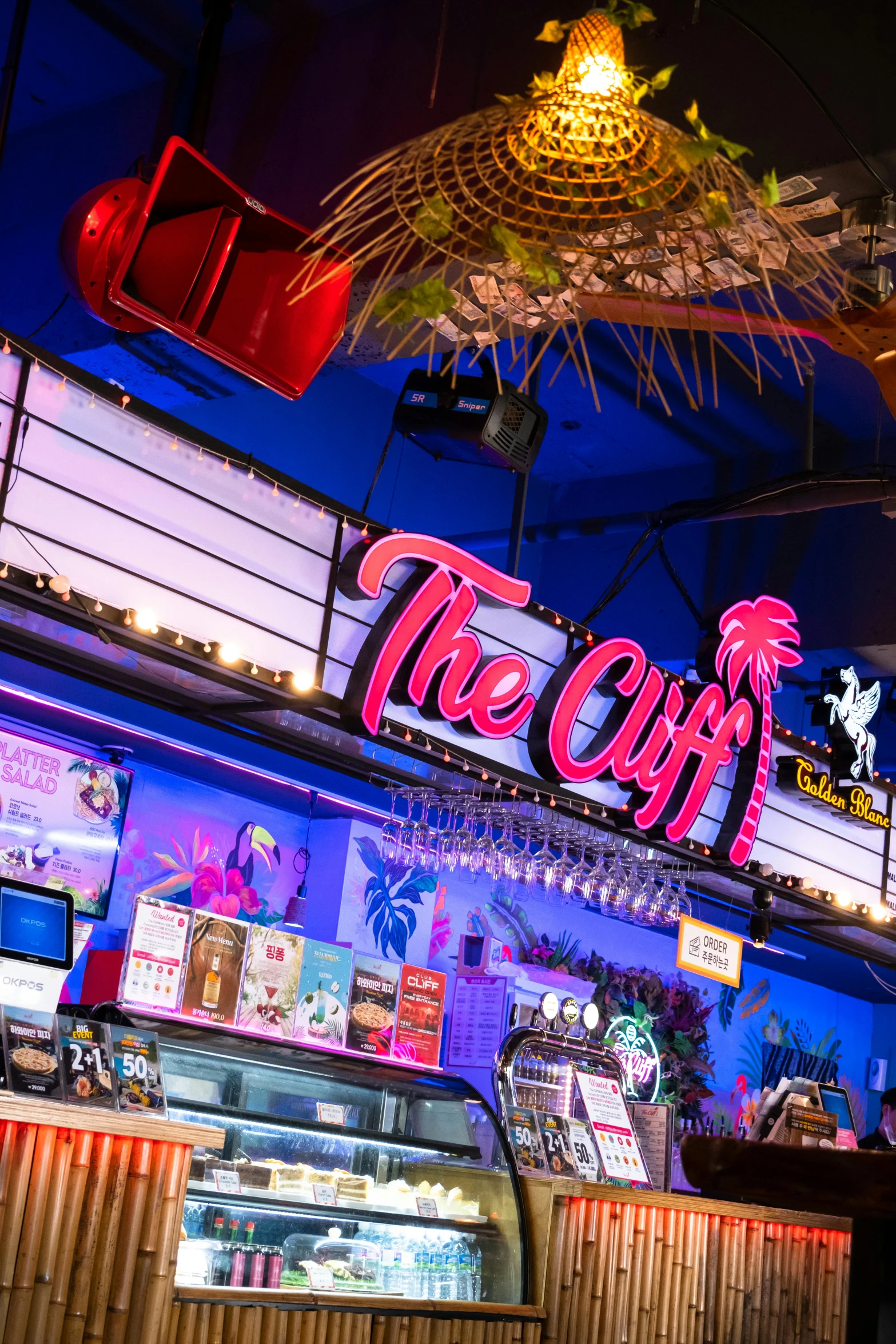 the entrance of the eatery and its neon signage